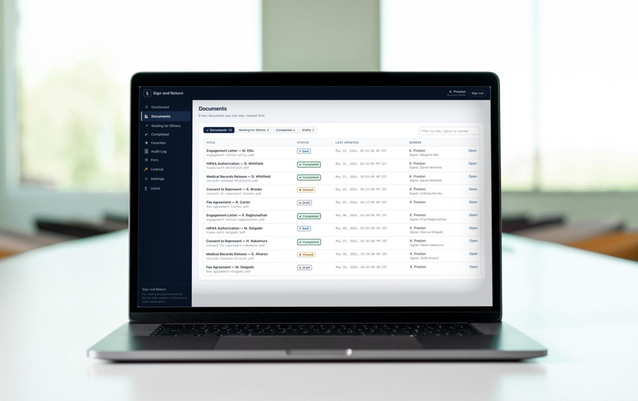 The Sign and Return documents list open on a laptop in an office